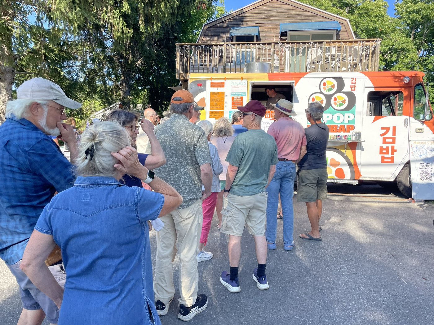 Customers lined up at the K-Pop Kimbap truck on a sunny day